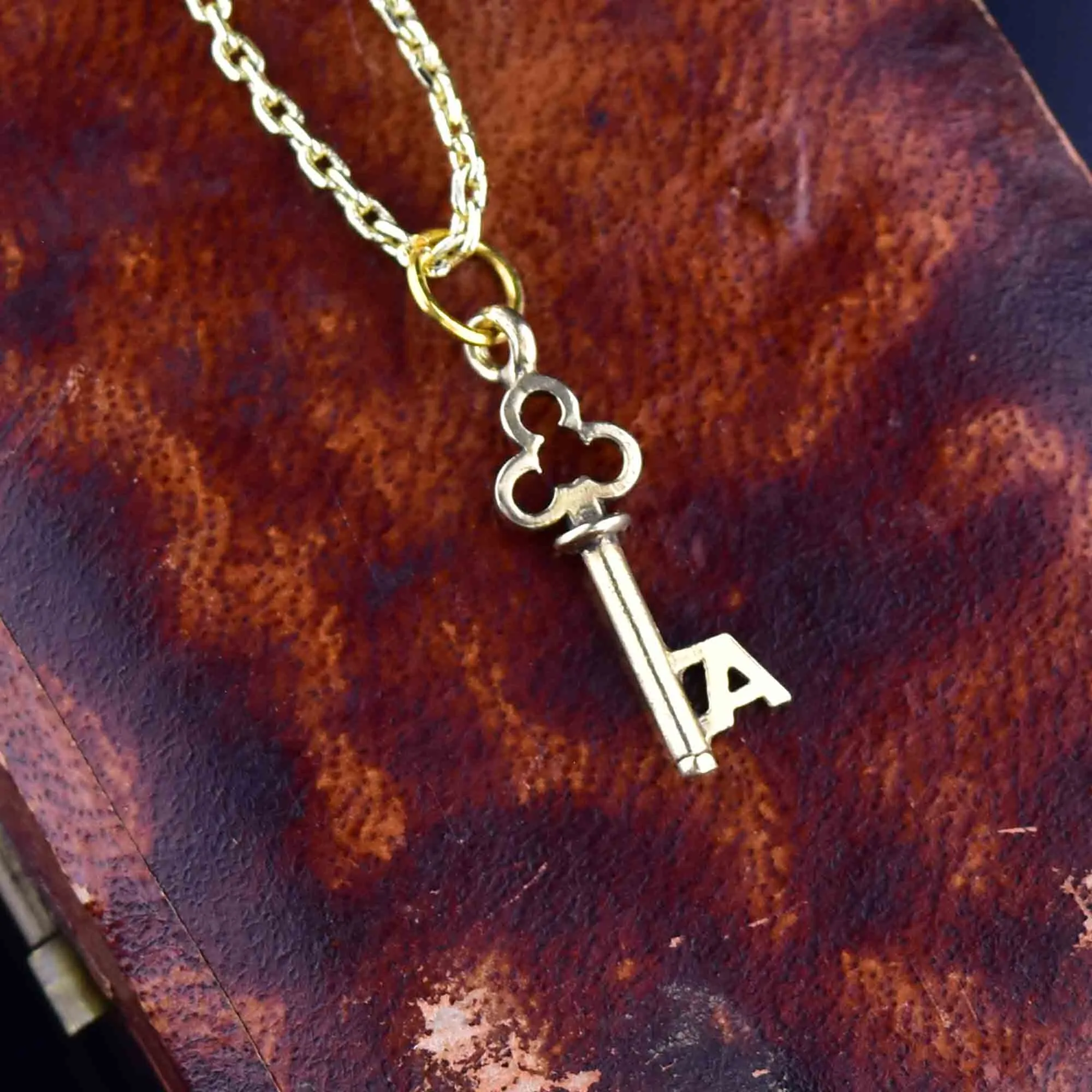 A Monogram Skeleton Key Necklace in 14K Gold